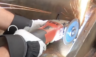 Cutting straight lines between drilled corner holes with an angle grinder