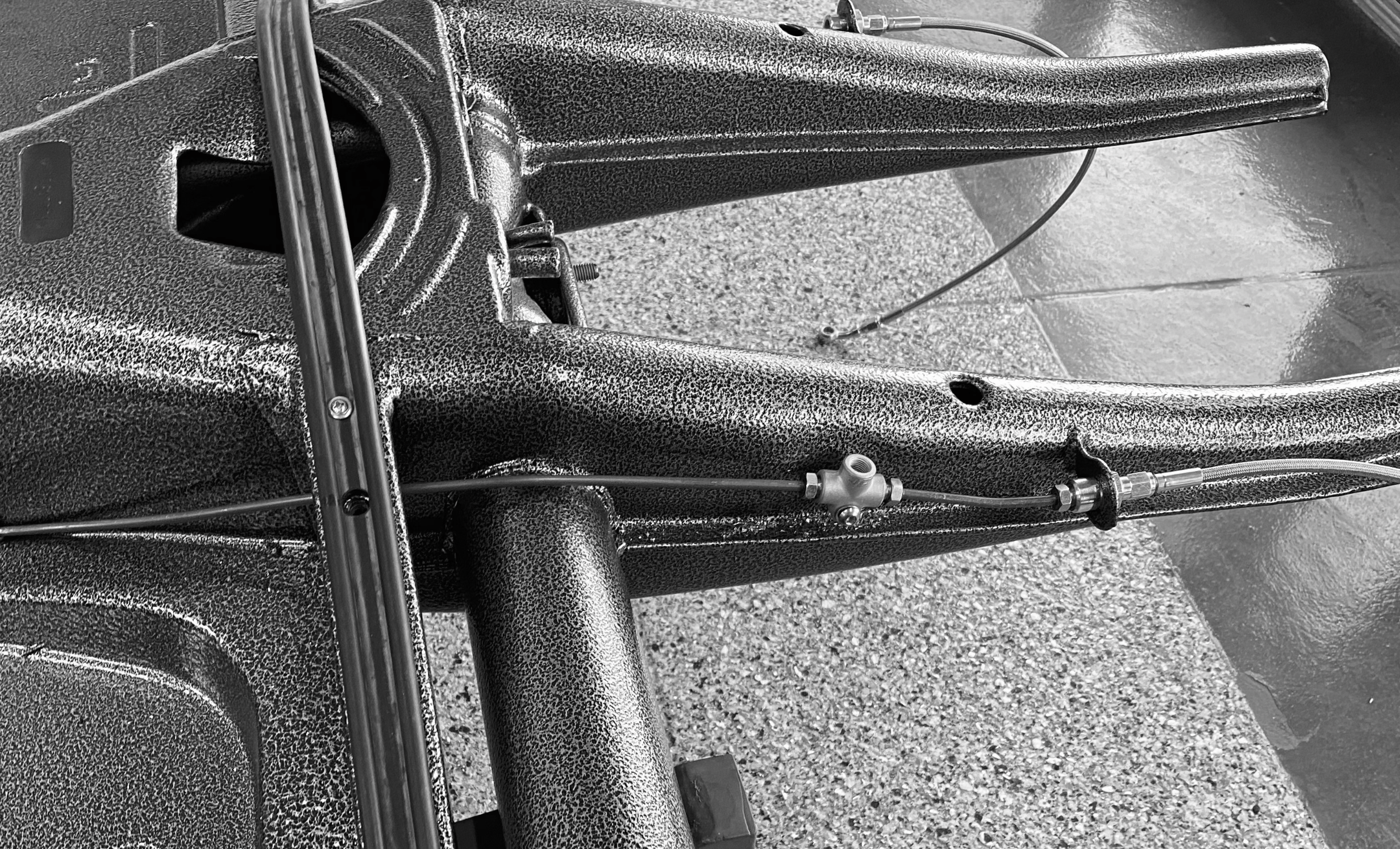 Trimming the factory hardline flush so the chassis exits are clear