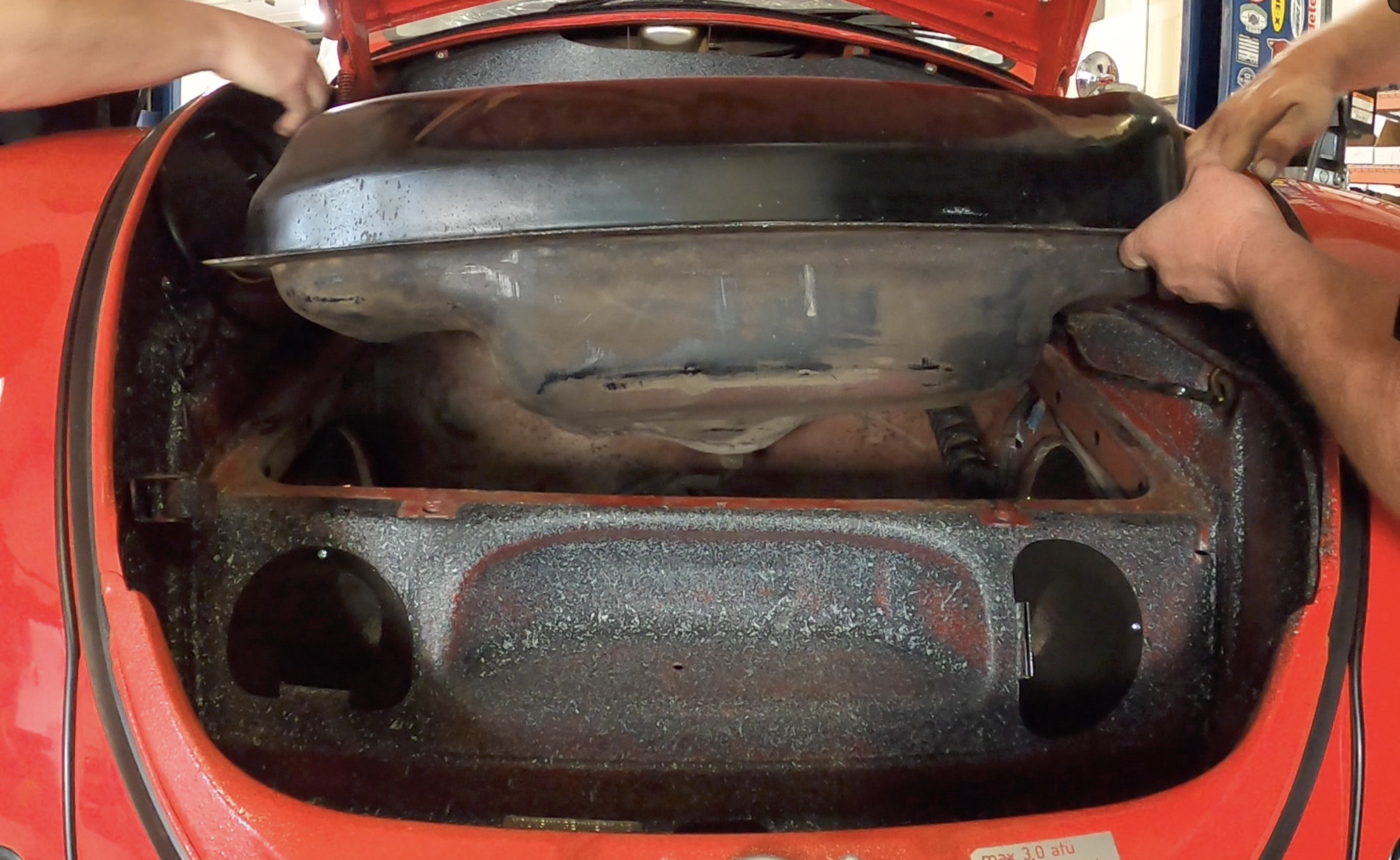 Removing the fuel tank from the front trunk of a classic VW