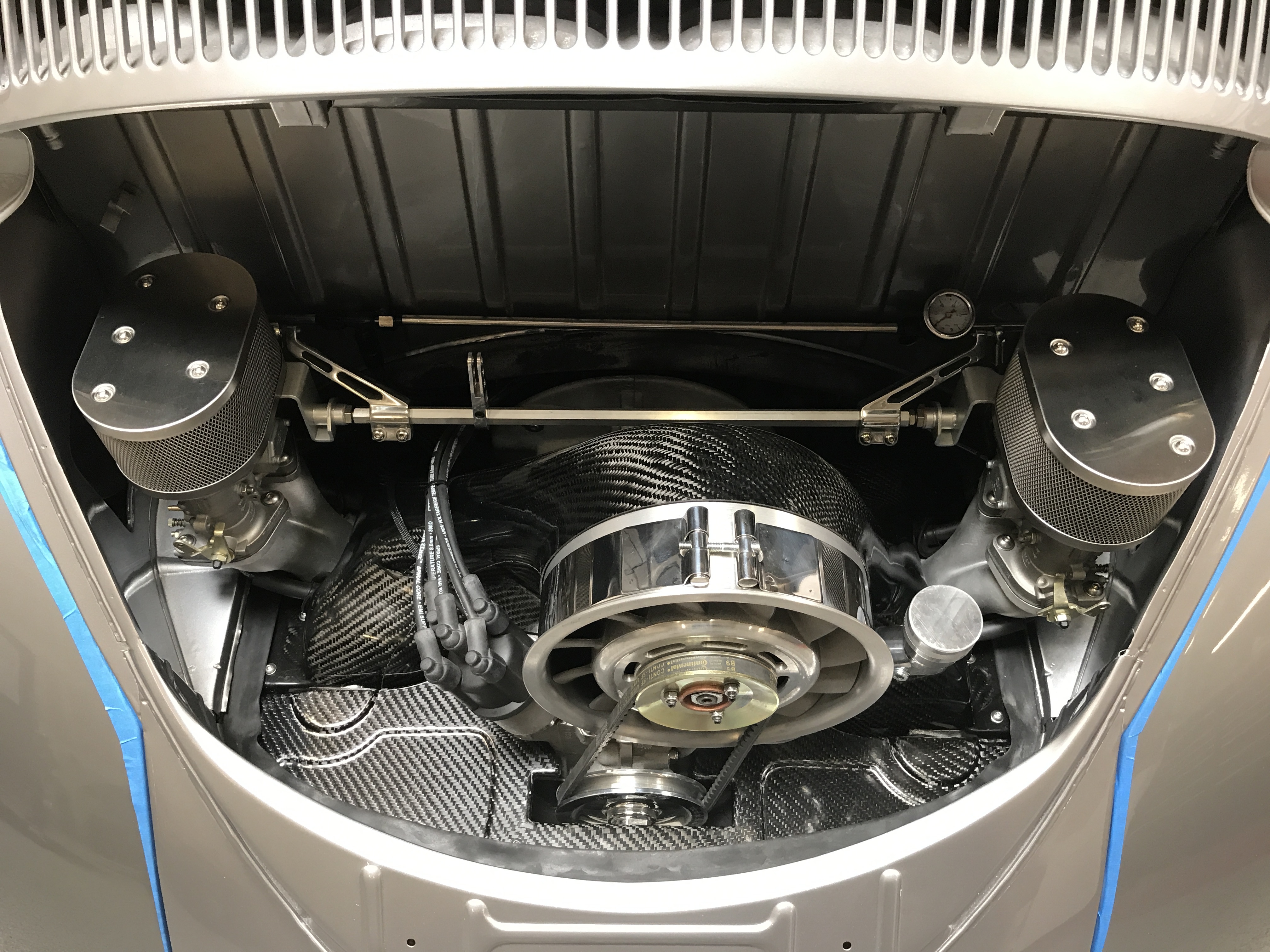 Close-up of stainless steel hardline fuel system installed on a classic VW engine bay