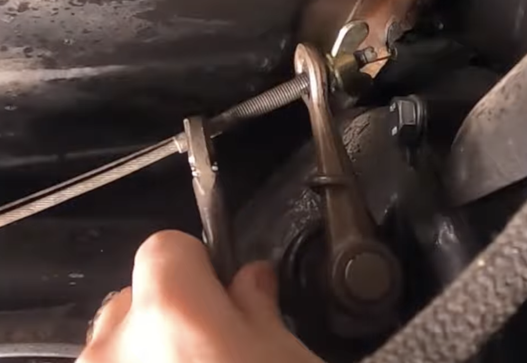 Removing the factory wing nut from the clutch cable