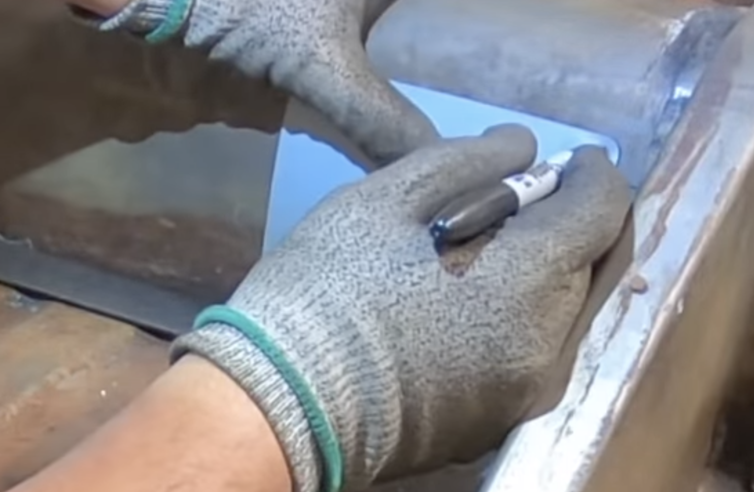 Marking screw holes through the inspection plate onto the tunnel