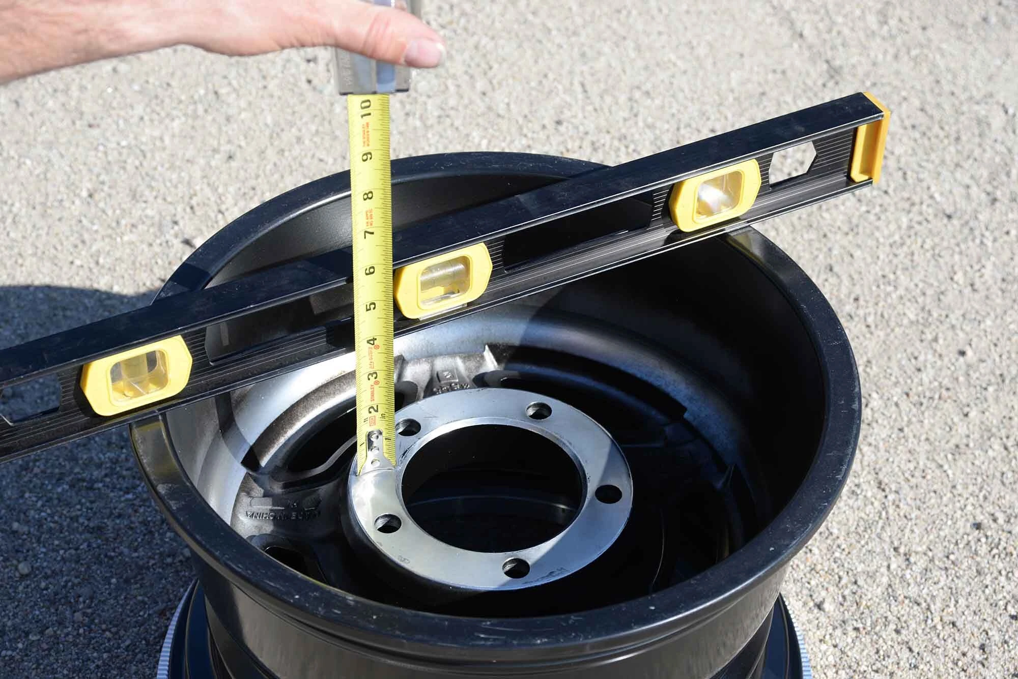 measuring wheel backspacing on a classic VW wheel with a straightedge