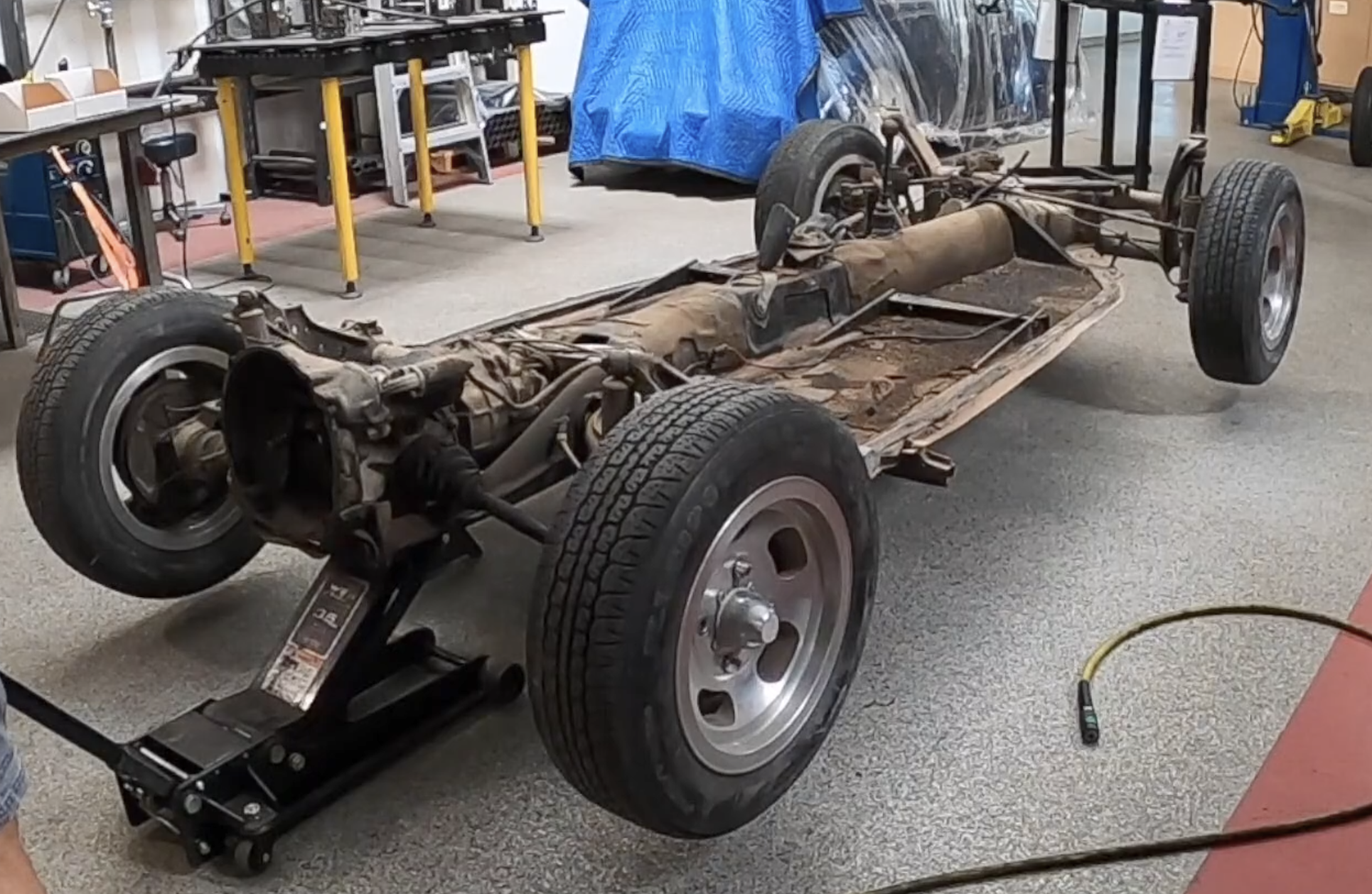 Car on jack stands, rear wheels off, ready to start the IRS air-ride install