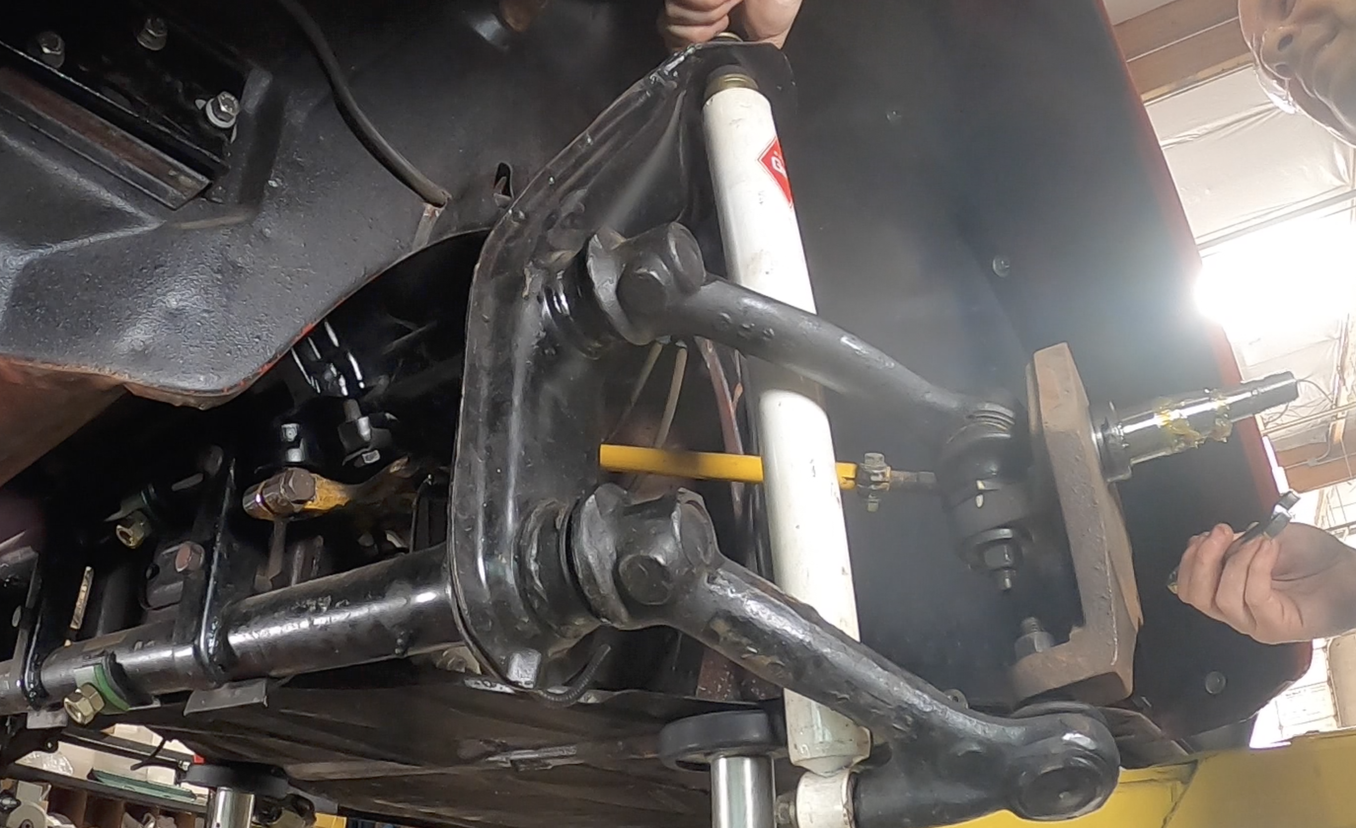 Front end on jack stands, drum off, spindle hanging &mdash; beam disassembly in progress