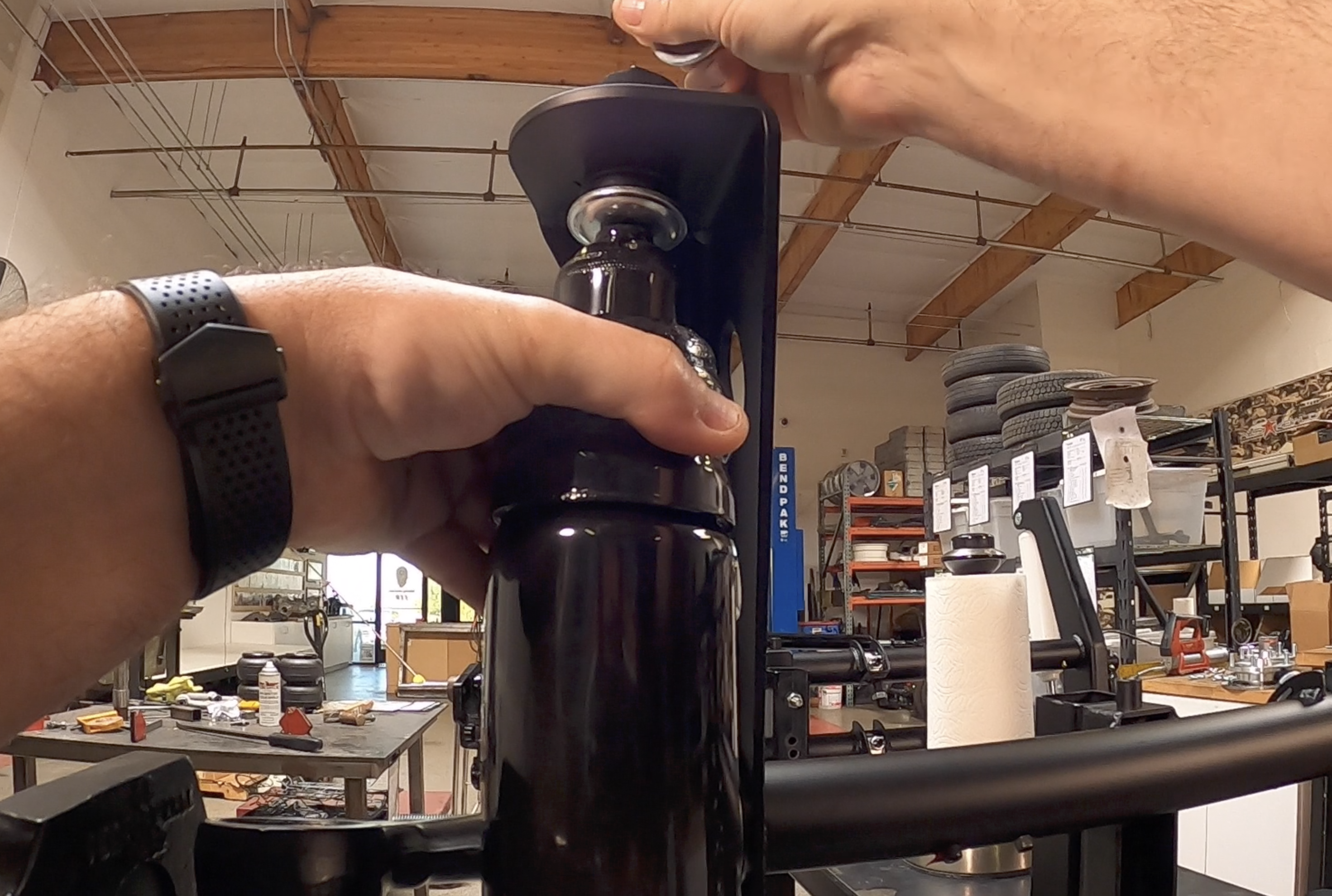 Air sleeve shock installed with fittings facing the front of the vehicle