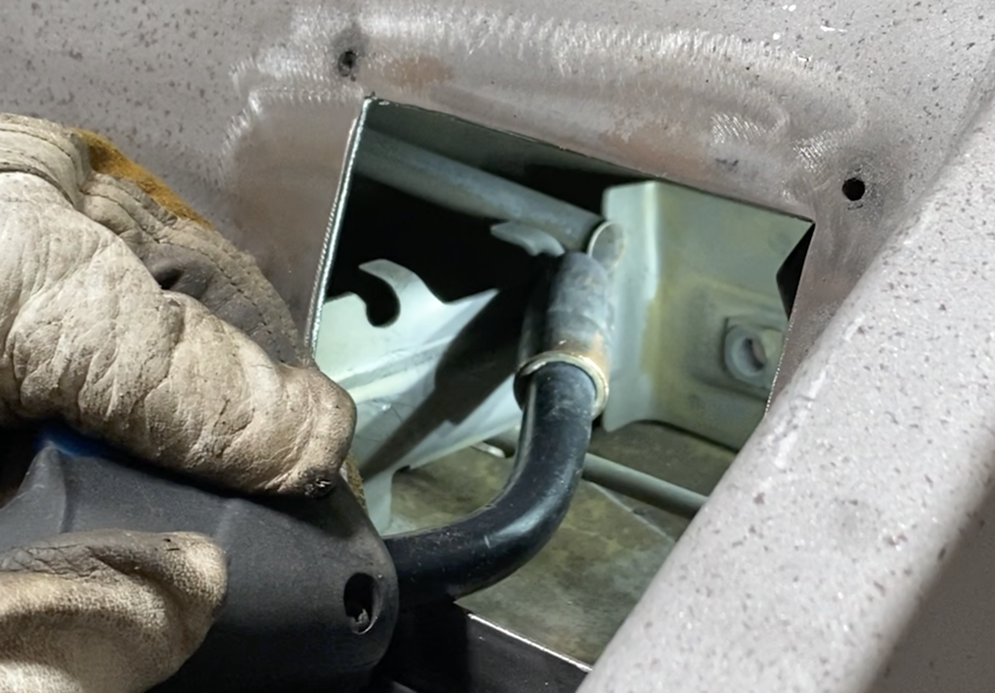 Clutch tube re-welded to its bracket through the new inspection plate access